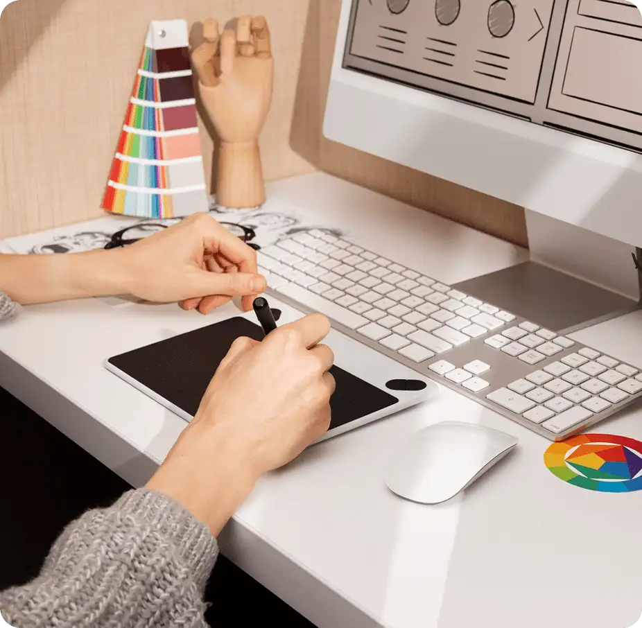 Design Services depicted with designer, desk, tablet and computer